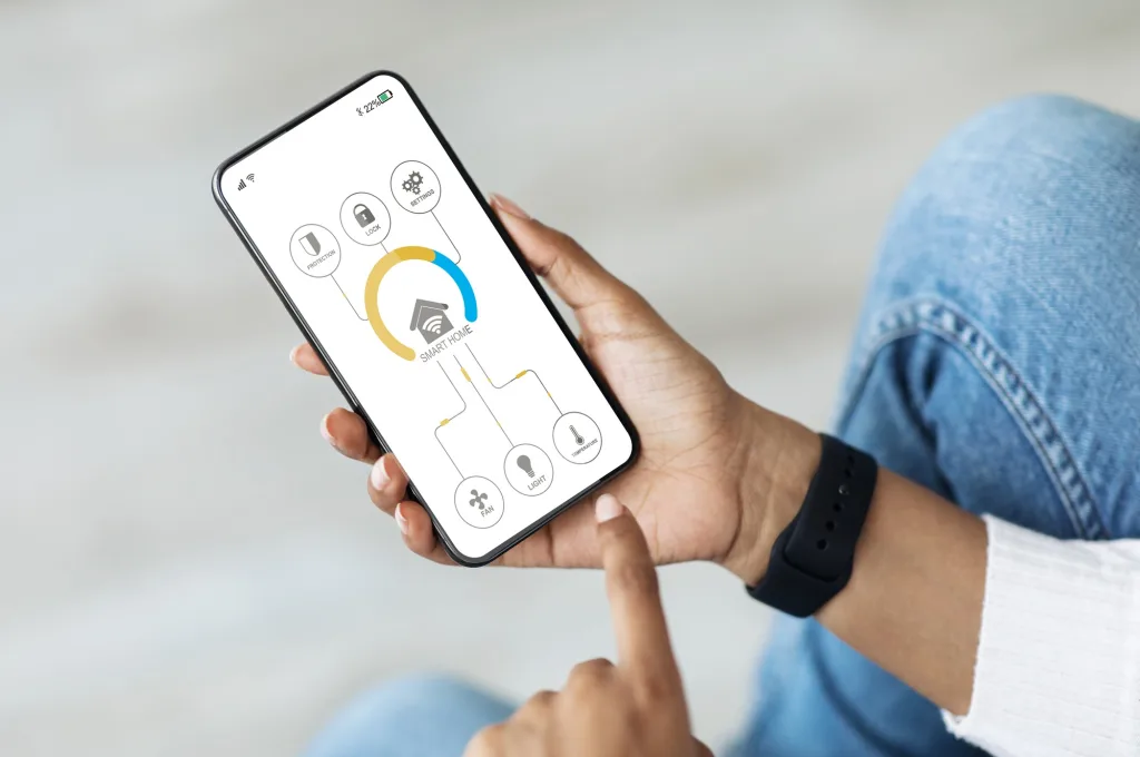 African american woman using smart home automation assistant on cellphone